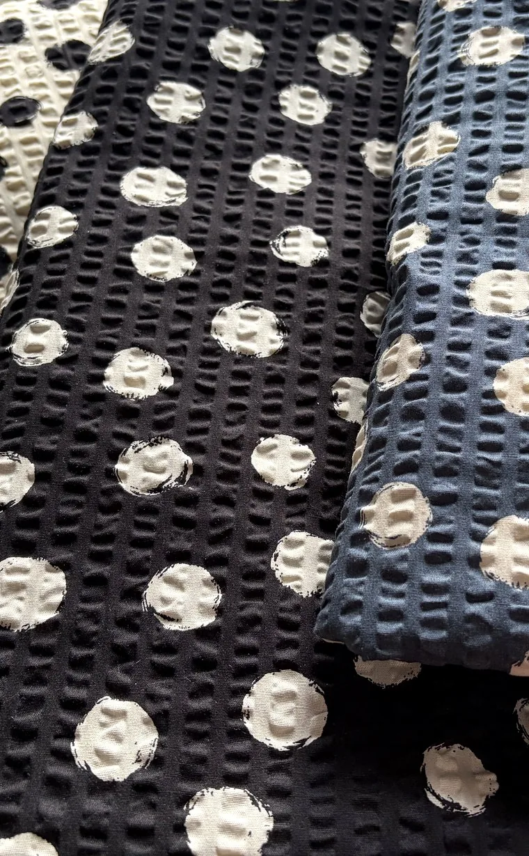 Cream, black and navy seersucker fabrics with painted polka dots