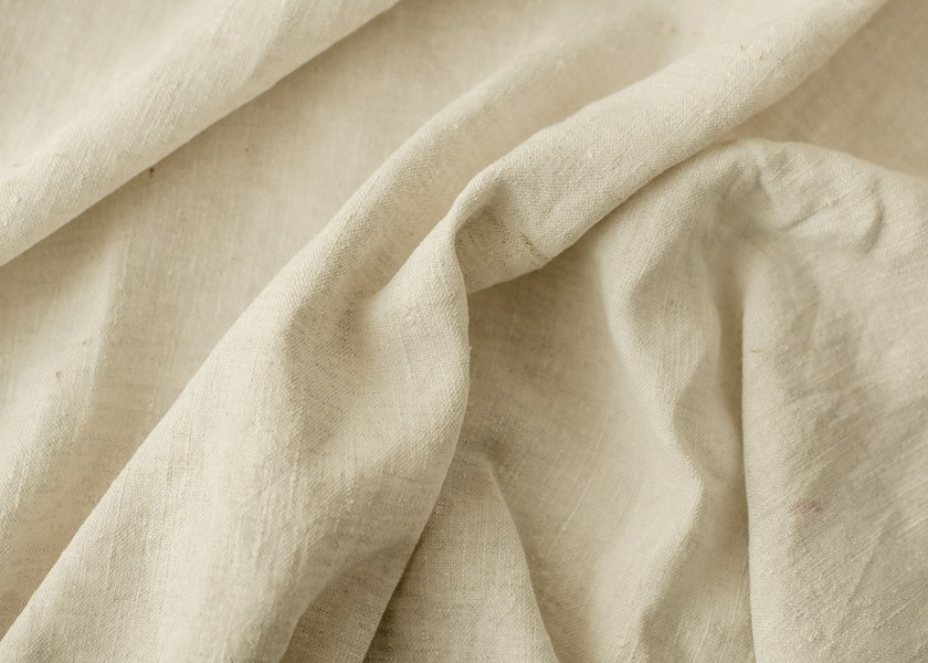 Close-up of natural linen folds showing the weave and texture