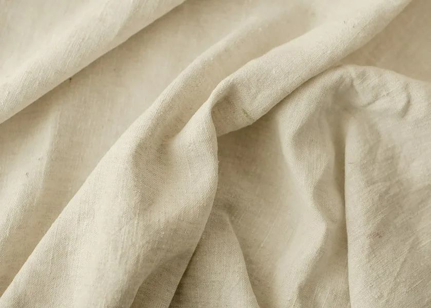 Close-up of natural linen folds showing the weave and texture