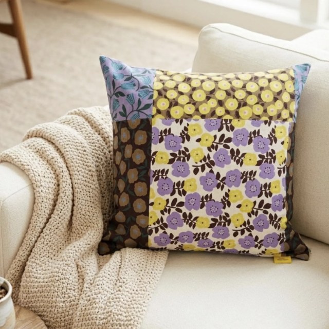 Floral Patchwork Sunset Lavender Kyoto cotton pillow cover on a cream sofa