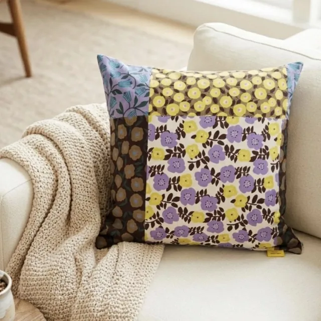 Floral Patchwork Sunset Lavender Kyoto cotton pillow cover on a cream sofa